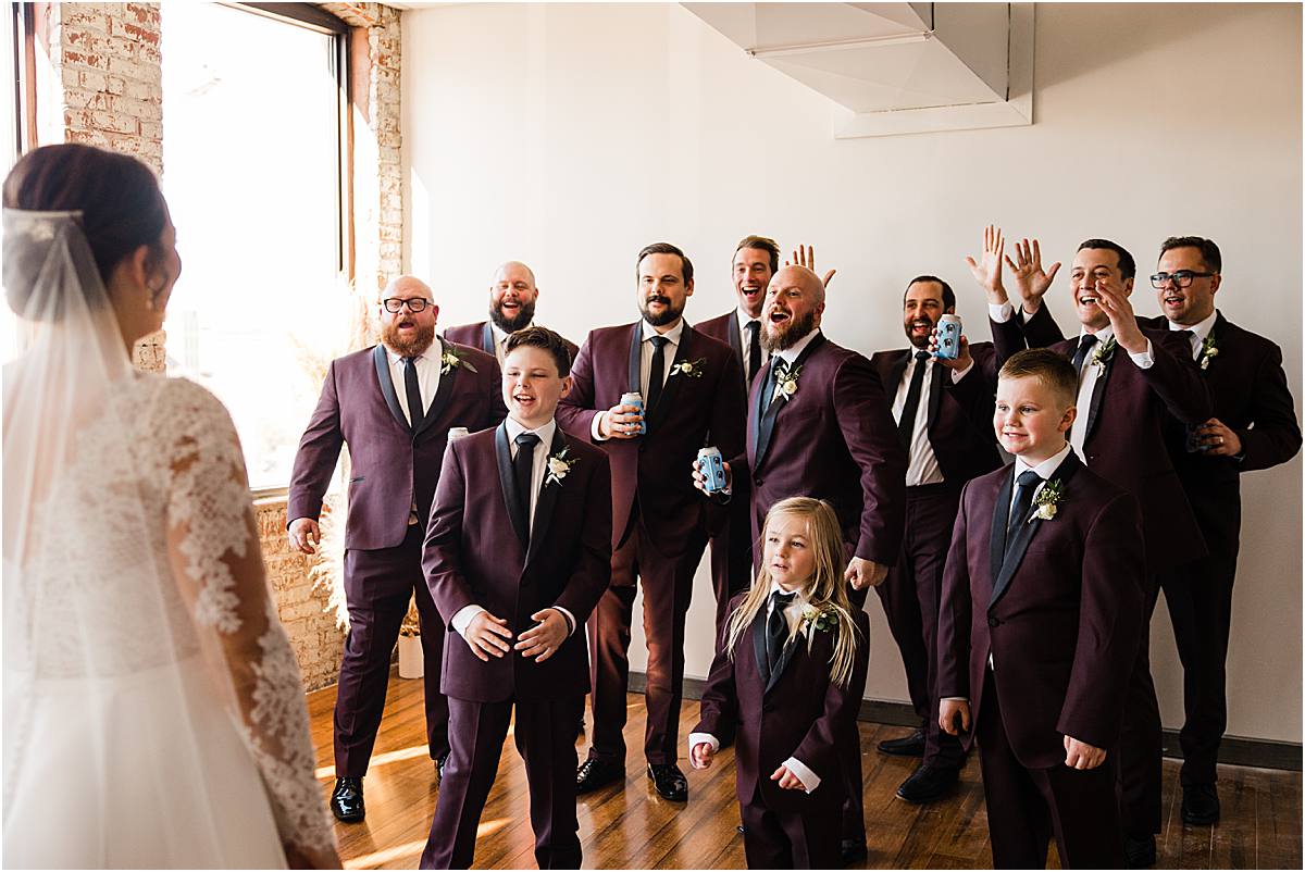 Brides first look with groomsmen at Magnolia Venue and Urban Garden by Kansas City Photographer West Rose Photo and Film