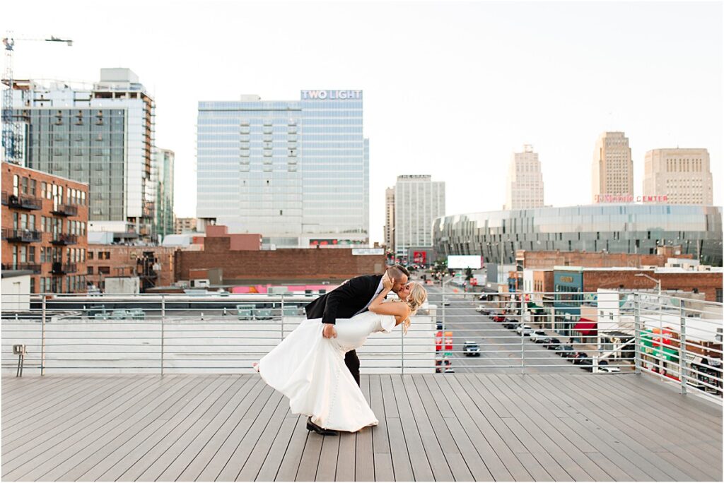 Bride and Groom kiss at The Bardot rooftop Downtown Kansas City Wedding 